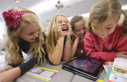 Francisco Kjolseth  |  The Salt Lake Tribune
Freedom Elementary 2nd graders, Avery Sherratt, Kate Durfey, Hannah Dajany and Lilly Adams, from left, crack up when the movements of their robot don't go as planned while using code instruction on an iPad on Tuesday, Dec. 10, 2013 in Highland, Utah.