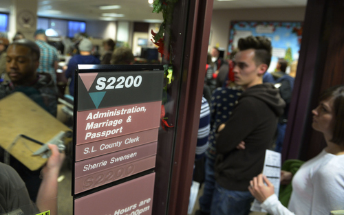 Keith Johnson | The Salt Lake Tribune

Dallin Stokes stands in line with others to get a marriage license at the Salt Lake County clerks office, Friday, December 20, 2013. A federal judge in Utah Friday struck down the state's ban on same-sex marriage, saying the law violates the U.S. Constitution's guarantees of equal protection and due process.