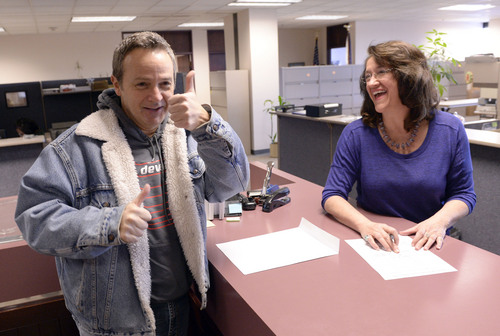 Al Hartmann  |  The Salt Lake Tribune
Michael Braxton, who legally performed a marriage for a same sex couple on Saturday, records the certificate with Deputy Clerk Wany Santos Morrison with Salt Lake County Clerk's Office Monday Jan. 6, 2014.  He was  worried that the Supreme Court stay would affect the legality of the marriage but since it took place before the stay the clerk's office recorded it. He was relieved and gave a thumbs up when the officer recorded  the license.