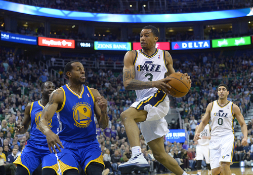 Scott Sommerdorf   |  The Salt Lake Tribune
Trey Burke drives and looks to pass as he is defended by Andre Iguodala during second half play. The Golden State Warriors beat the Utah Jazz 95-90, Friday, Jan. 31, 2014.