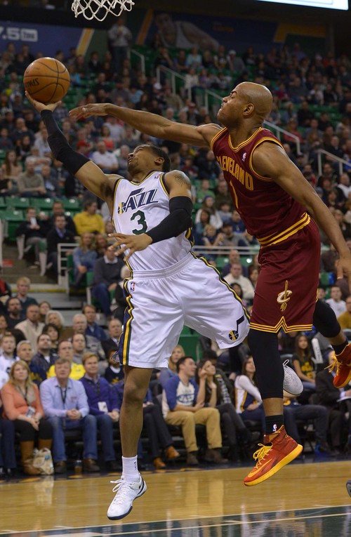 Leah Hogsten  |  The Salt Lake Tribune
Utah Jazz point guard Trey Burke (3) sinks the shot and draws the foul on Cleveland Cavaliers point guard Jarrett Jack (1). The Utah Jazz leads the Cleveland Cavaliers 49-46 at the half, Friday, January 10, 2014 at Energy Solutions Arena.