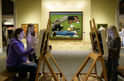 Francisco Kjolseth  |  The Salt Lake Tribune
Rachael Lever of Layton uses an interactive art easel along with her daughters, Ellie, 11, and Meg, 9, at right, as the Church History Museum opens a new exhibit titled  "Practicing Charity: Everyday Daughters of God." The seven-month exhibition features the works of three Latter-day Saint artists: Lee Bennion, Brian Kershisnik, and Kathy Peterson. The artists were chosen because their pieces honor women, highlighting the joy in life's small moments. The exhibit features interactive elements for kids.