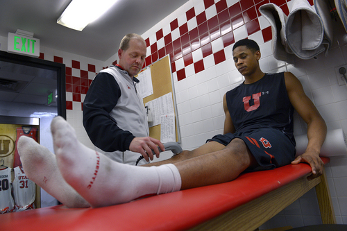 Scott Sommerdorf   |  The Salt Lake Tribune
Utah trainer Trevor Jameson treats Princeton Onwas' knee after an informal practice, Thursday, Feb. 27, 2014. Jameson is battling a rare form of bone marrow cancer, and in the months ahead will need a bone marrow transplant.