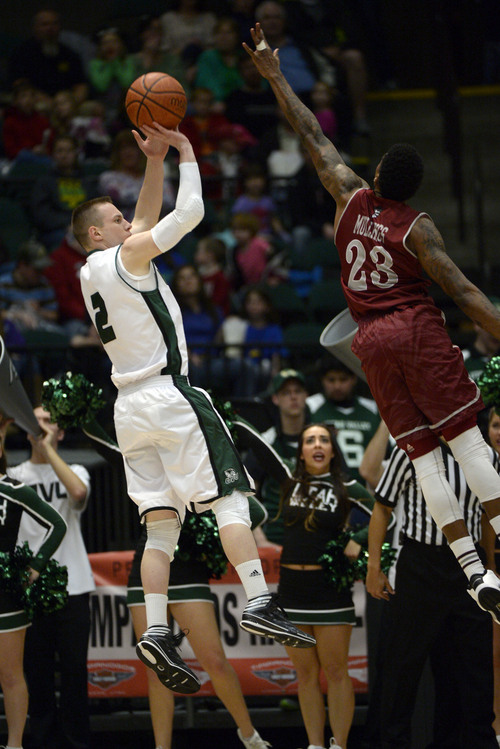 Francisco Kjolseth  |  The Salt Lake Tribune
Utah Valley Wolverines guard Hayes Garrity (2) tries to get past New Mexico State Aggies guard Daniel Mullings (23) in game action at Utah Valley University in Orem on Thursday, Feb. 27, 2014.
