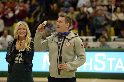 Francisco Kjolseth  |  The Salt Lake Tribune
Utah Valley University alumni Chris Fogt, bronze medalist in the four-man bobsled at the 2014 Winter Olympics, is honored alongside his wife Rachel during the UVU vs New Mexico State basketball game at the UCCU Center in Orem on Thursday, Feb. 27, 2014.