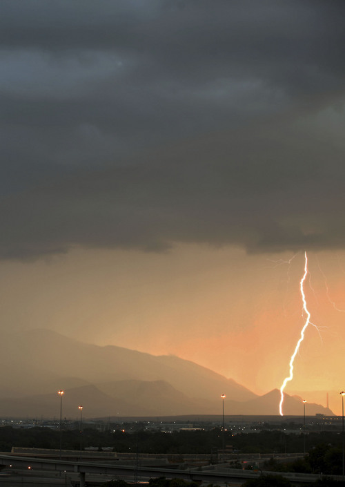 Lennie Mahler  |  The Salt Lake Tribune
Lightning strikes west of Salt Lake City over I-15 as the Sun sets Saturday, Sept. 1, 2012.