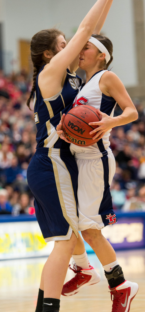 Trent Nelson  |  The Salt Lake Tribune
Skyline's Laurel Tomlinson draws a charging foul on Springville's Savannah Park as Springville faces Skyline High School in the 4A girls high school basketball tournament state championship game in Taylorsville, Saturday, March 1, 2014.