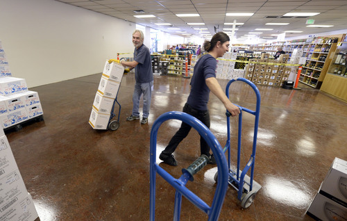 Francisco Kjolseth  |  The Salt Lake Tribune
Paul Schneller, left, and Pete Gonzales make way for new wine racks at the liquor store in Sugar House. In a few weeks, customers may get relief from long check-out lines and limited booze selection at the state liquor store, as former warehouse space is now being converted over. The remodeling of the 1,904-square-foot store will more than double the amount of floor space. The remodel should be done by March 10.
