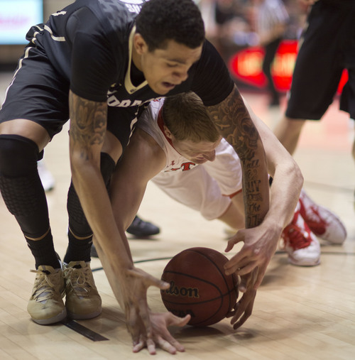 Lennie Mahler  |  The Salt Lake Tribune
Utah's Jeremy Olsen dives on a loose ball under Colorado's Dustin Thomas in the second half of a game at the Huntsman Center, Saturday, March 1, 2014.