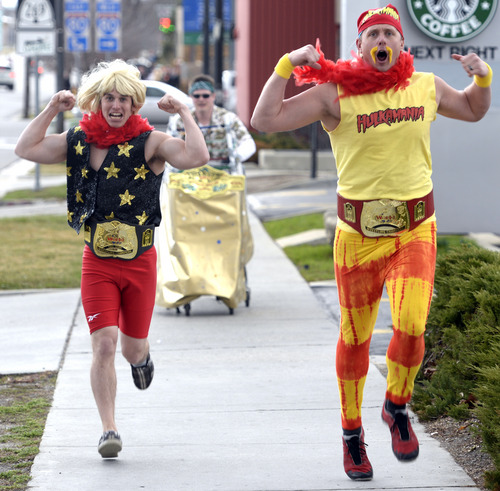 Rick Egan  | The Salt Lake Tribune 

Rick Flair (left) and Terry Hogan (right) race through downtown Salt Lake City in the urban Iditarod, pulling shopping carts and making rest stops along the way at local pubs and clubs, Saturday, March 1, 2014.