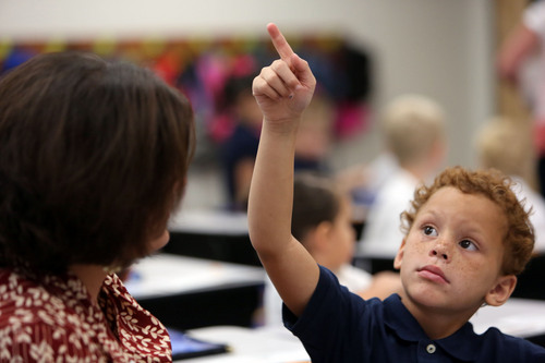 Francisco Kjolseth  |  The Salt Lake Tribune
Using his finger to trace letters, James Turner, 5, who has autism, practices what he needs to write down as he attends kindergarten for the first time. With the help of aide, Mrs. Christy Johnson, he regains focus and keeps from disrupting the rest of the class.