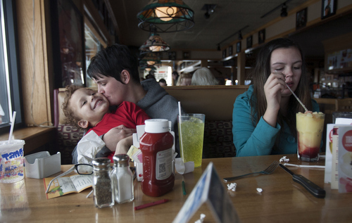 Kim Raff  |  The Salt Lake Tribune
Angie Watterson gives her son, James Turner, a hug and kiss during a rare outing for lunch at Applebees in Tooele on February 9, 2013. The Stansbury Park boy, who has autism, is one of more than 300 children enrolled in a Medicaid lottery providing free therapy.