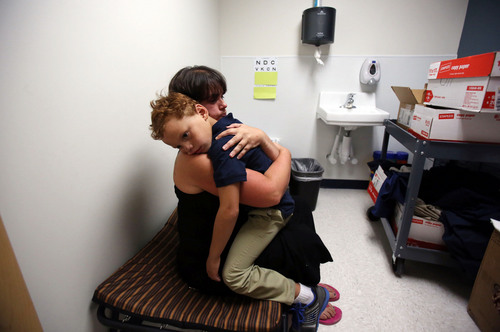 Francisco Kjolseth  |  The Salt Lake Tribune
Angie Watterson gives her son James Turner, 5, a "deep strong" hug following a tantrum at school as a way to refocus his nervous system, a technique she learned through his months of therapy.