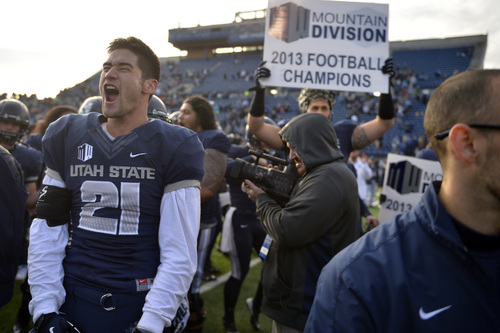 Chris Detrick  |  The Salt Lake Tribune
Utah State Aggies safety Brian Suite (21) celebrates after the game at Merlin Olsen Field at Romney Stadium Saturday November 30, 2013.  Utah State defeated Wyoming 35-7. The Aggies will visit Fresno State in the title game next Saturday to complete their first season of MW competition.