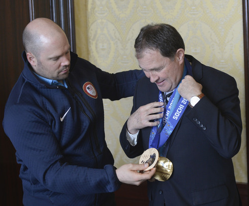 Al Hartmann  |  The Salt Lake Tribune 
Park City olympian Steve Holcomb stops in at Governor Gary Herbert's office Monday March 3 to show him his two bronze medals he won at the Sochi Olympics.   He also had his gold medal from Vancouver 2010 Olympics.  He was pilot for the two-man and four-man bobsled teams.