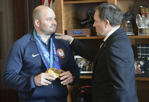 Al Hartmann  |  The Salt Lake Tribune 
Park City olympian Steve Holcomb stops in at Gov. Gary Herbert's office Monday March 3 to show him his two bronze medals he won at the Sochi Olympics.  He also had his gold medal from Vancouver 2010 Olympics.  He was pilot for the two-man and four-man bobsled teams.