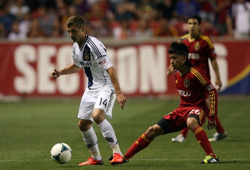 Kim Raff  |  The Salt Lake Tribune
(right) Real Salt Lake midfielder Sebastian Velasquez (26) defends (left) LA Galaxy player Robbie Rogers as he looks to pass during the second half at Rio Tinto Stadium in Salt Lake City on June 8, 2013.  Real went on to win the game 3-1.