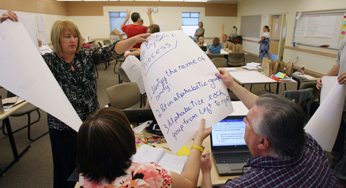 Steve Griffin | The Salt Lake Tribune
Utah high school teachers swap instructions during a June 2013 workshop at Westminster College in Salt Lake City that trained them how to teach a new elective course called "Exploring Computer Science.