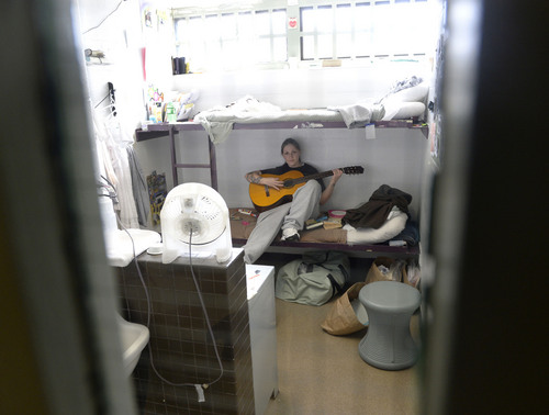 Al Hartmann  |  The Salt Lake Tribune 
Brandi Walker, a resident inmate in the ExCell program in the Timpanogos unit at the Utah State Prison finds some quiet time to practice guitar in her cell. The cells are shared by two women. The ExCell program is for women undergoing substance-abuse treatment.
