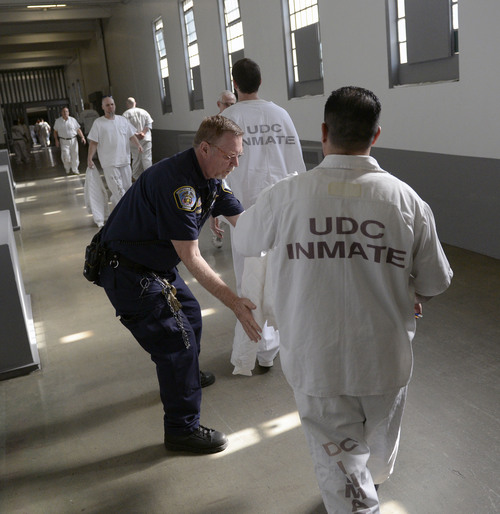 Al Hartmann  |  The Salt Lake Tribune 
A corrections officer at the Utah State Prison frisks inmates for metal objectsas they return to their cells after working such facilities as the license plate facility or the commissary.