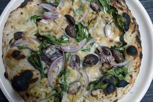 Al Hartmann  |  The Salt Lake Tribune 
Spinach and Roasted Artichoke Pizza with black olive, tallegio, house ricotta and red onion at Bistro 222.