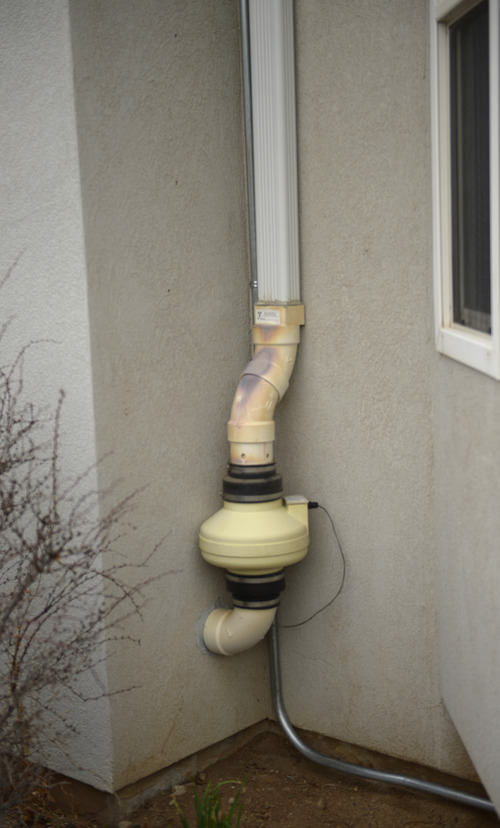 Rick Egan  | The Salt Lake Tribune 

Radon mitigation equipment installed in the Poulsen home in Sandy, vents radon outside the home. Thursday, March 6, 2014. Jan Poulsen was diagnosed to lung cancer that was caused from radon accumulating in her Sandy home.
