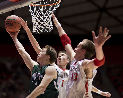Lennie Mahler  |  The Salt Lake Tribune
Olympus' Jordan Meacham puts up a shot over Bountiful's Zac Seljaas and Jeff Pollard in the second half of a semi-final game against Olympus at the Huntsman Center, Friday, March 7, 2014.