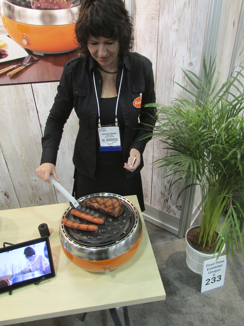 Tom Wharton | The Salt Lake Tribune
Marjolein Smedema of The Netherlands shows off the Grillerette, a small appliance designed to barbecue indoors or out using charcoal.
