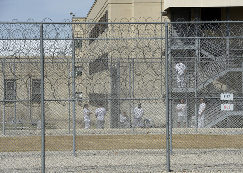 Al Hartmann  |  The Salt Lake Tribune 
Inmates at the Utah State Prison in Draper spend some free time outside the old Wasatch unit built in the early 1950's.  They are surrounded by three high fences with razor wire.
