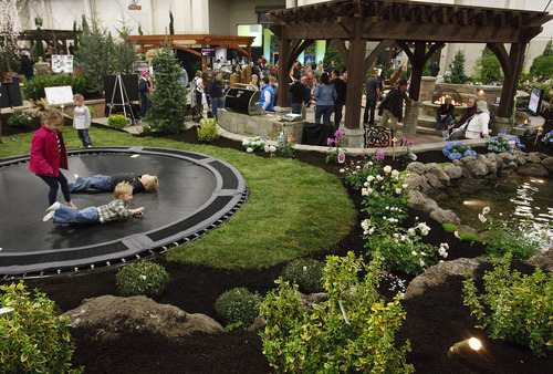 Leah Hogsten  |   Tribune file photo
Kids jump on the trampoline as adults sit and listen to the massive display from Decorative Landscaping of American Fork at the 2013 Salt Lake Tribune Home and Garden Show at the South Towne Expo Center. This year's show runs Friday through Sunday.