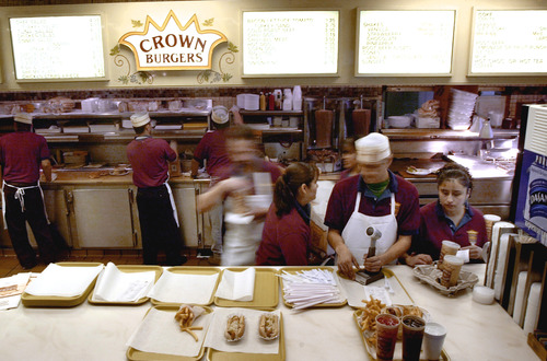Employees work at Crown Burger in Salt Lake City. Across the nation, college graduates are taking low-wage posts, displacing the less educated as jobs can be difficult to find. Tribune file photo