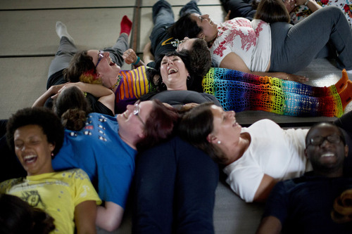 FILE - People laugh as they take part in performing a group exercise during a laughter yoga class in St. Albans, England. A survey co-hosted by The Salt Lake Tribune is asking for nominations of companies that allow employees to work happy. (AP Photo/Matt Dunham)