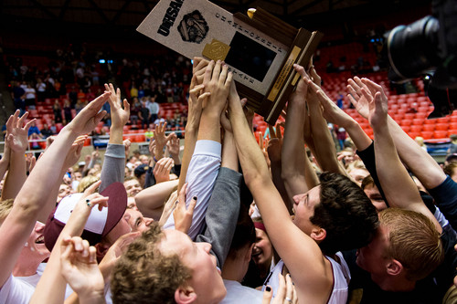 Trent Nelson  |  The Salt Lake Tribune
Lone Peak fans collapse around the championship trophy after Lone Peak defeated Pleasant Grove High School in the 5A state championship boys basketball game at the Huntsman Center in Salt Lake City, Saturday, March 8, 2014.