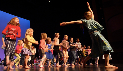 Rick Egan  | The Salt Lake Tribune 

Deja Mitchell leads teh children in an African dance during the "Ring Around the Rose" dance class at Rose Wagner Performing Arts Center, Saturday, March 8, 2014.  Andy Jones from Djembe Direct and the African Heartwood Project and dancer Deja Mitchell lead the kids African drumming and dancing in the cultural dancing styles of West Africa