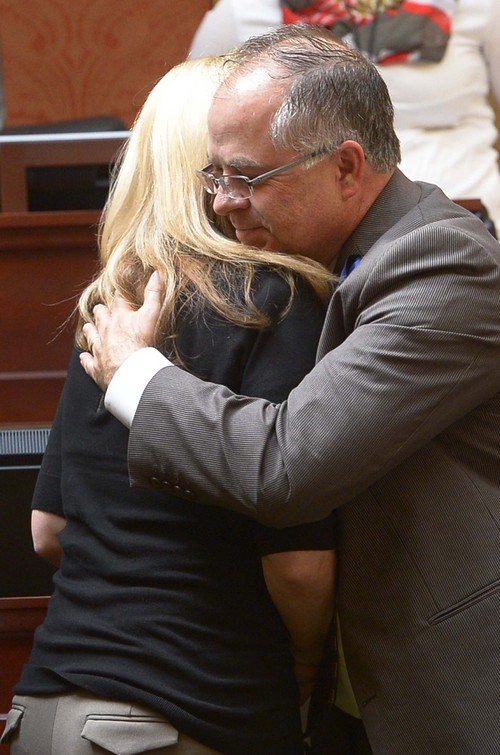 Leah Hogsten  |  The Salt Lake Tribune
Nannette Wride receives a hug from bill co-sponsor Rep. David Lifferth in the House chambers after the legislators voted to rename SR-73 to the Cory B. Wride Memorial Highway in Utah County, Wednesday, March, 12, 2014 in honor of Nannette husband who was killed during a shootout along the highway in January.