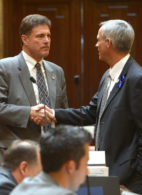 Leah Hogsten  |  The Salt Lake Tribune
Rep. Jim Dunnigan, R-Taylorsville, chairman of the investigative committee is congratulated by Rep. Kay Christofferson, (right) after Dunnigan presented the final report, Wednesday, March, 12, 2014, to the Utah House, into former Attorney General John Swallow.  A stack of more than 200 pages with 3,700 exhibits was submitted as the result of a four-month, $4 million investigation, which contributed to Swallow's resignation.