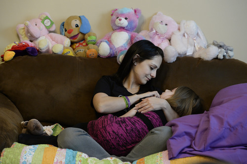 Francisco Kjolseth  |  The Salt Lake Tribune
Catrina Nelson of West Jordan holds her youngest daughter Charlee, 6, who suffers from Late Infant Batten Disease, a terminal inherited disorder of the nervous system that leads to seizures, loss of vision and motor skills. Surrounded by friends and family, they stay close to Charlee, feeling her spirit at home during hospice care.