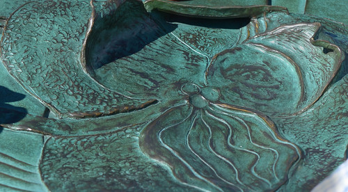 Leah Hogsten  |  The Salt Lake Tribune
A bronze sculpture of what The Draw will look like once completed, Thursday, March, 13, 2014. The Draw at Sugar House Park will link a "Sego Lily" sculptured dam with flood walls and a spillway that ties together Sugarhouse Commons with Sugar House Park. The north petal of the Sego Lily, which has 30-foot high walls, tips over to become an overlook; the south petal forms a bus shelter; and a parapet along the highway offers a view of the plaza and entrance to the pedestrian crossing below.