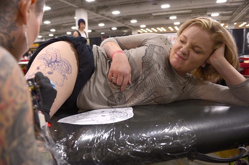 Leah Hogsten  |  The Salt Lake Tribune
"I really love elephants," said Lynnzie Van Leuven grimacing as tattoo artist Arpil Cornell hits a painful spot on her leg at the Salt Lake City International Tattoo Convention, Friday, March, 14, 2014. It runs through Sunday at the Salt Palace Convention Center. The show features vendors, contests and more than 150 tattoo artists.