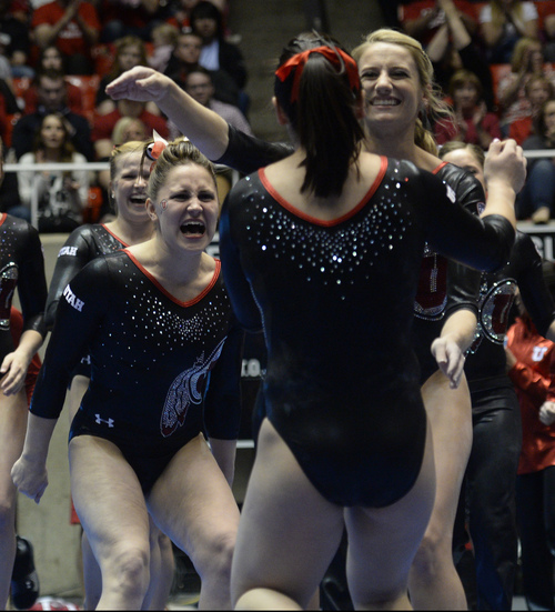 Rick Egan  | The Salt Lake Tribune 

Becky Tutka and Mary Beth Lofgren  greet Corrie Lothrop, after her performance on the beam for the Utes, in gymnastics action, Utah vs. Georgia, Saturday, March 15, 2014.