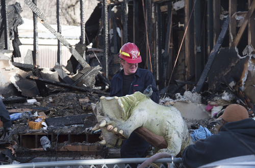 Steve Griffin  |  The Salt Lake Tribune


A Provo Fire and Rescue firefighter removes a stuffed dinosaur as they sift through the rubble of a house at 1214 E. 520 South in Provo, Utah after it exploded and burned Sunday, March 16, 2014.
