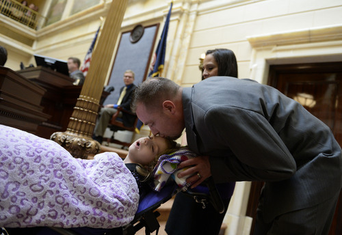 Francisco Kjolseth  |  The Salt Lake Tribune
Catrina and Jeff Nelson alongside their daughter, Charlee, 6, who suffered from Late Infant Batten Disease, a terminal inherited disorder of the nervous system. The family was acknowledged on the Senate floor at the Utah Capitol after senators unanimously passed HB105,which would provide access to cannabis oil for epileptic kids, on Tuesday, March 11, 2014.