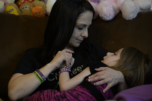 Francisco Kjolseth  |  The Salt Lake Tribune
Catrina Nelson of West Jordan holds her daughter Charlee, 6, who suffered from Late Infant Batten Disease, a terminal inherited disorder of the nervous system that leads to seizures and loss of vision and motor skills. Her daughter, who was on hospice care at home, was surrounded by friends and family as they comforted one another during her final moments.