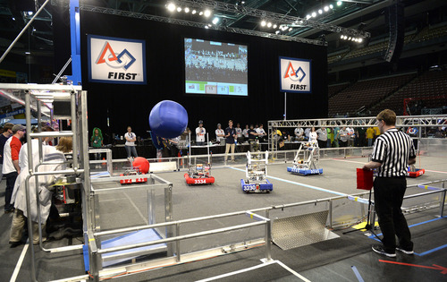 Rick Egan  | The Salt Lake Tribune 

Robots compete in "Aerial Assist,"  competition at the Maverick Center, Saturday, March 15, 2014.  Two robot alliances of three teams each vie to outscore each other during a two-and-a-half minute bout. Winners qualify for the national championship. Forty-eight robots created by almost 2,000 teenage engineers from nine western U.S. states and Alberta, Canada, will compete for the For Inspiration and Recognition of Science and Technology regional robotics competition. Cosponsored by the University of Utah College of Engineering.  The competition cultivates innovators and engineers from 22 Utah high schools and 26 others.  The "Aerial Assist," competition, is a volleyball-meets-soccer event. Two robot alliances of three teams each vie to outscore each other during a two-and-a-half minute bout. Winners qualify for the national championship.