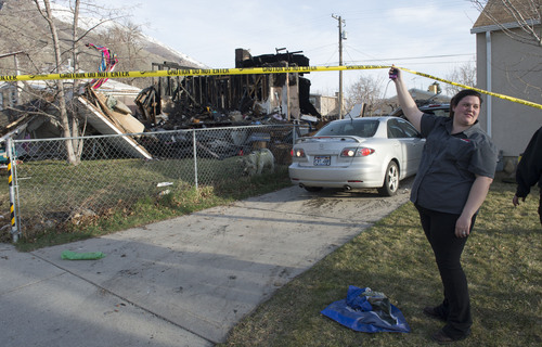 Steve Griffin  |  The Salt Lake Tribune


Bethany Christensen holds up police tape as her husband, Mike Christensen, backs up one of their cars after their next door neighbor's house at 1214 E. 520 South in Provo, Utah exploded and burned Sunday, March 16, 2014.