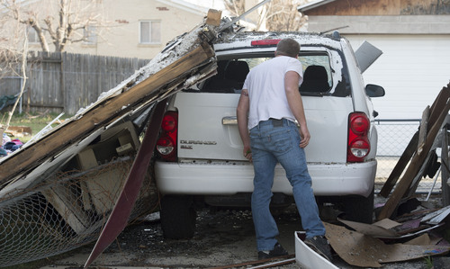 Steve Griffin  |  The Salt Lake Tribune


With the wall of his neighbor's house resting on his car, Mike Christensen, assesses the damage after his next door neighbor's house at 1214 E. 520 South in Provo, Utah exploded and burned Sunday, March 16, 2014.