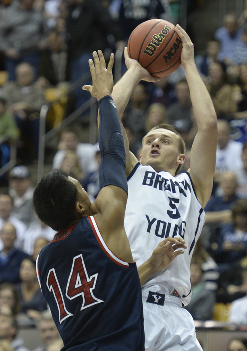 Rick Egan  | The Salt Lake Tribune 

Brigham Young Cougars guard Kyle Collinsworth (5) shoots over St. Mary's Gaels guard Stephen Holt (14) in basketball action, BYU vs. St Mary's, at the Marriott Center, Saturday, February 1, 2014.