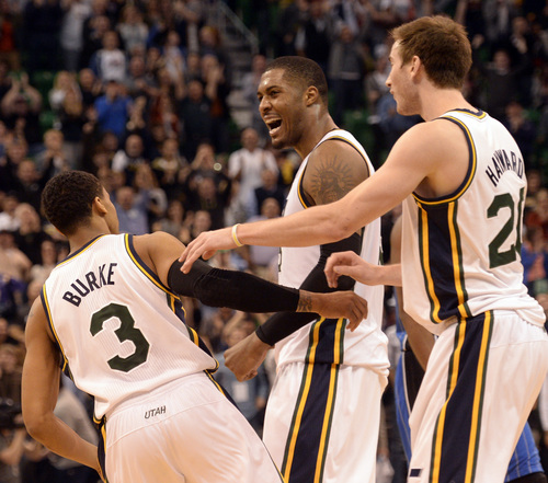 Rick Egan  | The Salt Lake Tribune 

Utah Jazz center Derrick Favors (15) and Utah Jazz guard Gordon Hayward (20) celebrate wtihTrey Burke (3)  after he hit the game winning 3-point shot with 1.6 seconds left in the game, going the Jass an 89-88 win over the Magic, in NBA action, The Utah  Jazz vs. the Orlando Magic, at EnergySolutions Arena Saturday, March 22, 2014.