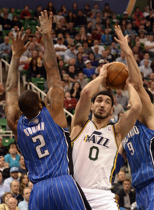 Rick Egan  | The Salt Lake Tribune 

Utah Jazz center Enes Kanter (0) tries to get a shot off, as he is guarded by Orlando Magic forward Kyle O'Quinn (2) and Orlando Magic center Nikola Vucevic (9), in NBA action, The Utah  Jazz vs. the Orlando Magic, at EnergySolutions Arena Saturday, March 22, 2014.
