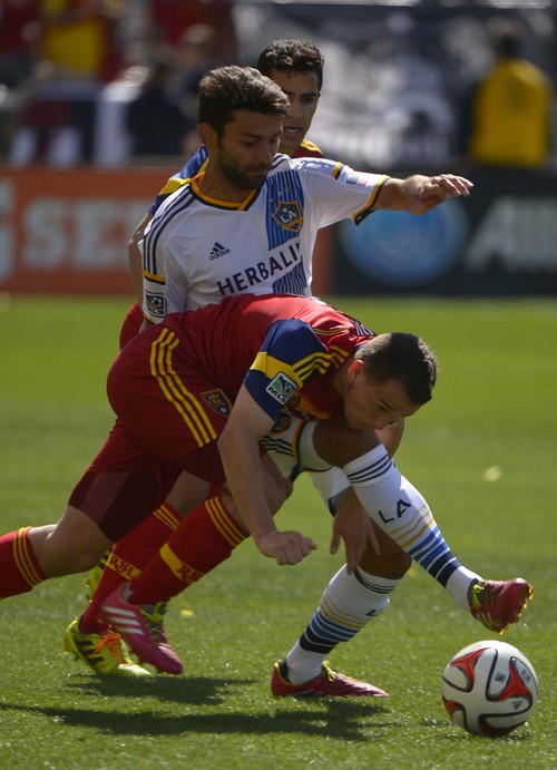 Leah Hogsten  |  The Salt Lake Tribune
Real Salt Lake midfielder Luis Gil (21) tussles with Los Angeles Galaxy midfielder Baggio Husidic (6). Real Salt Lake and the L.A. Galaxy are 1-1 at the half during Saturday's, March 22, 2014 home opener at Rio Tinto Stadium.
